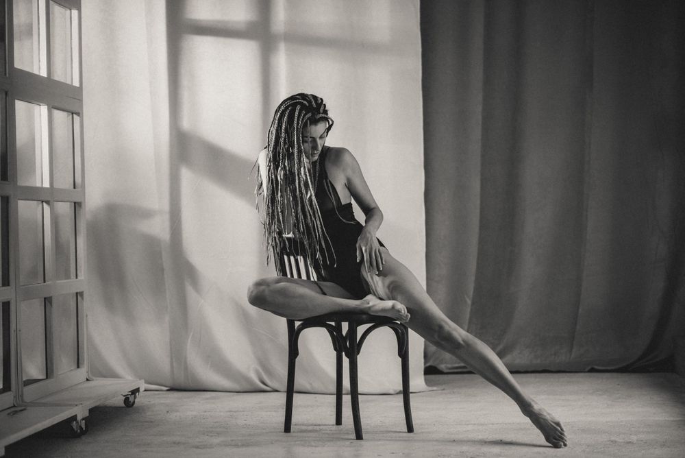Artistic sequence showing graceful dance movements in a minimalist studio setting with natural light.