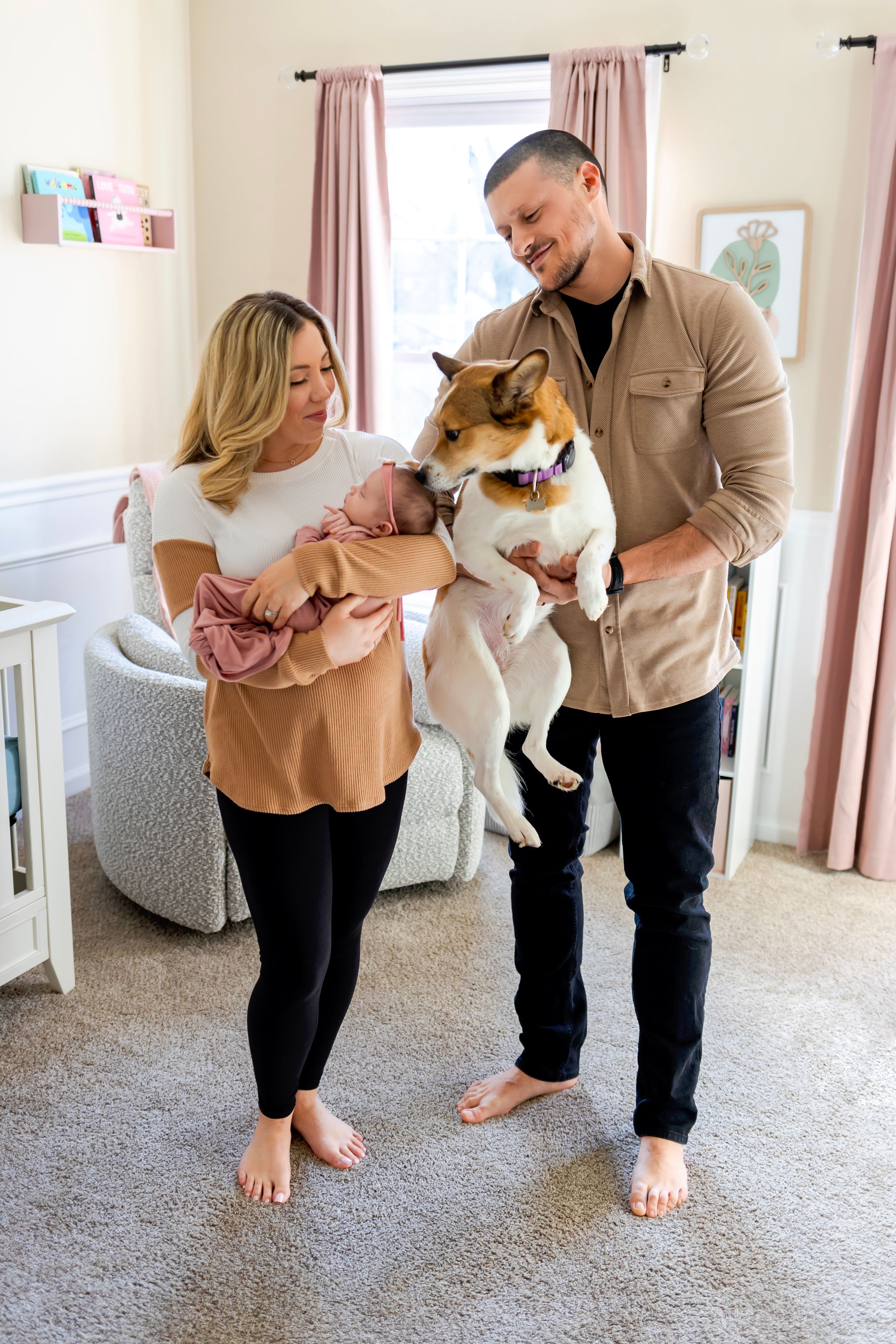 A family stands together in a cozy nursery. NJ Newborn Photographer in home session.