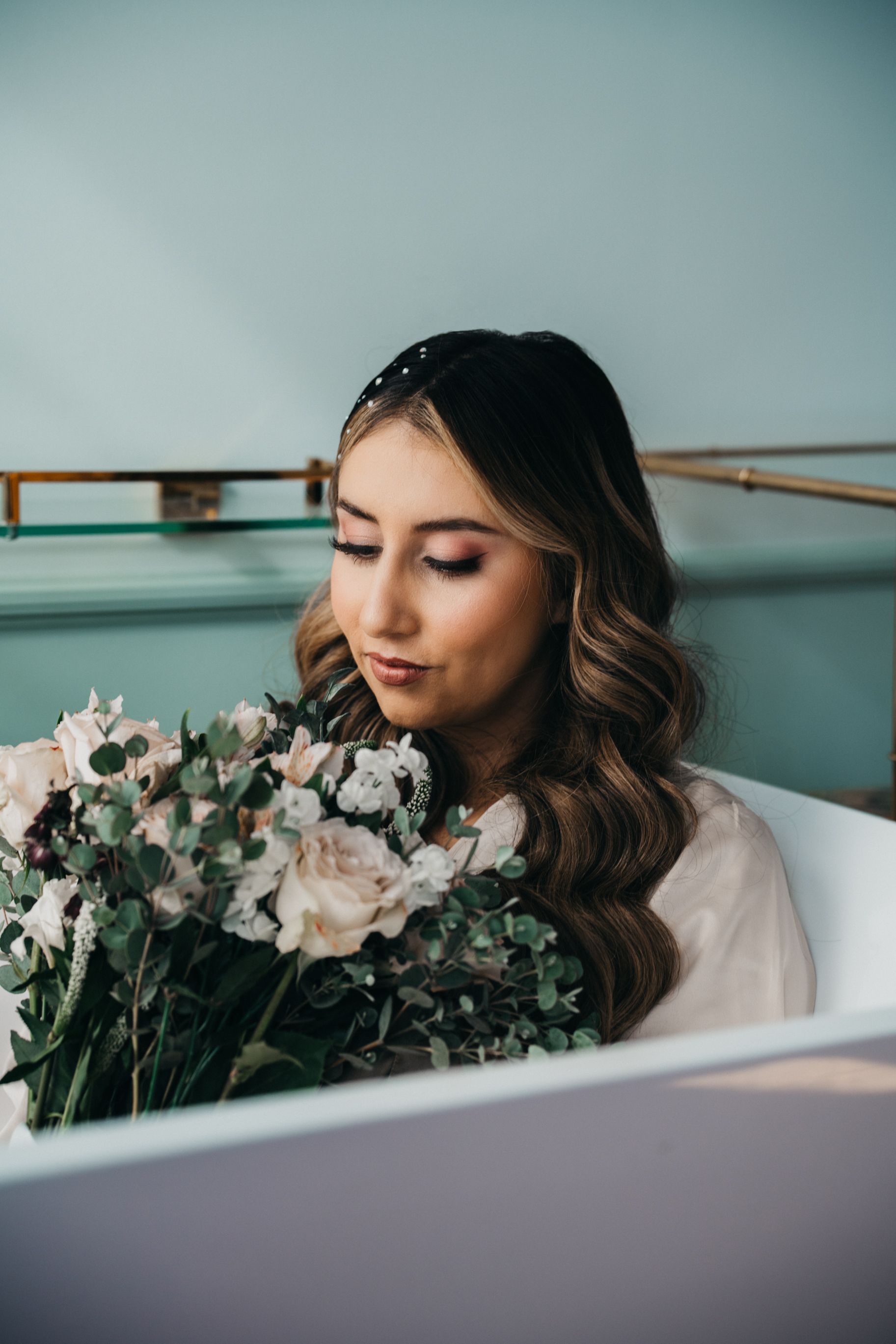 Romantic portrait with soft lighting of person holding delicate floral bouquet.