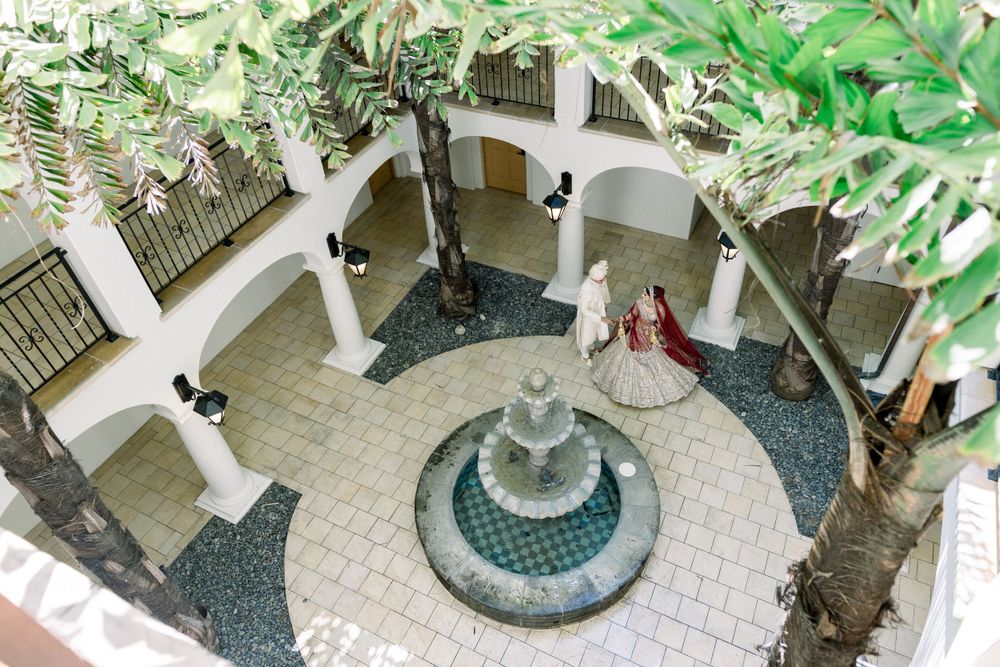 Outdoor courtyard with white columns and lush greenery creating a serene garden atmosphere.