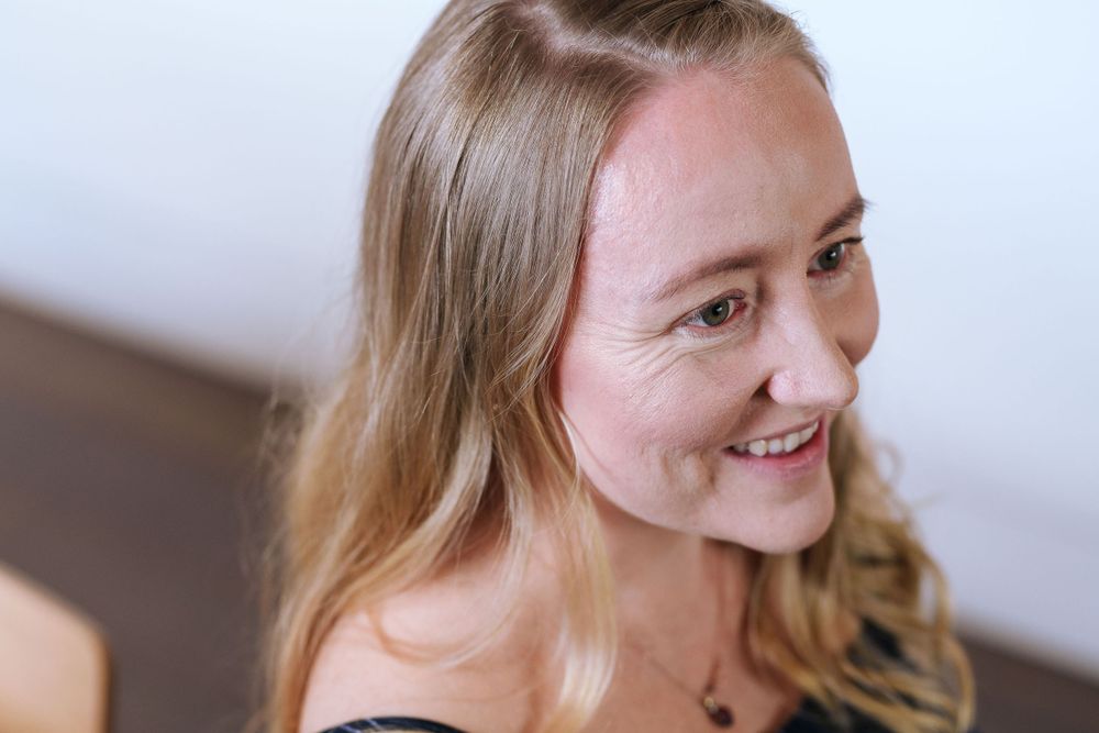 A close-up natural light portrait capturing genuine joy and warmth.