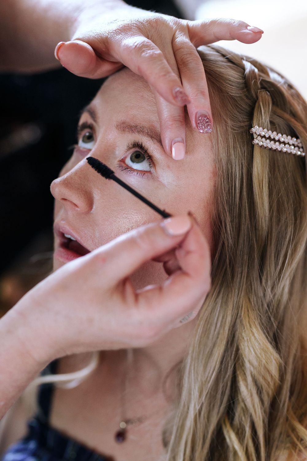 A detailed shot of mascara being applied during a makeup session.
