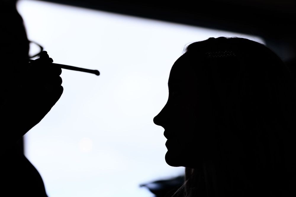 Dramatic silhouette profile of two figures against a bright backlight.