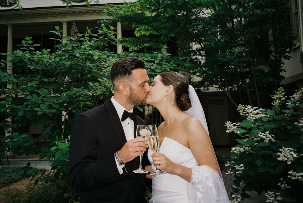 A romantic champagne toast moment in a garden setting.