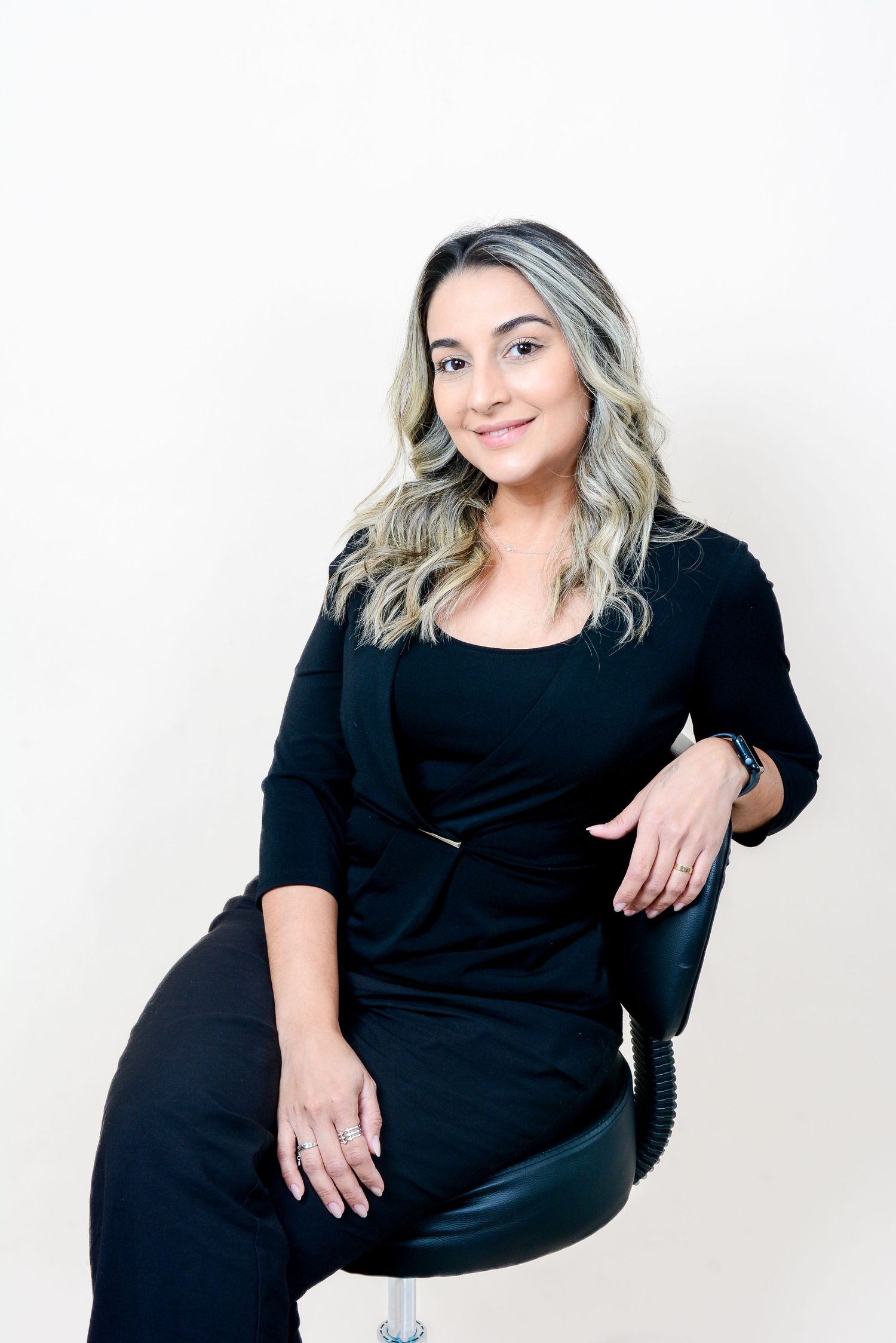 Studio portrait session with black dress against white background.
