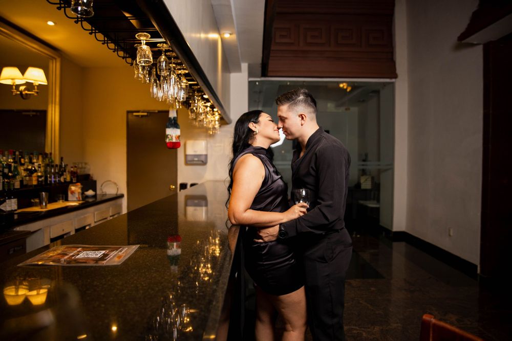 Couple sharing an intimate moment at a luxurious bar counter.