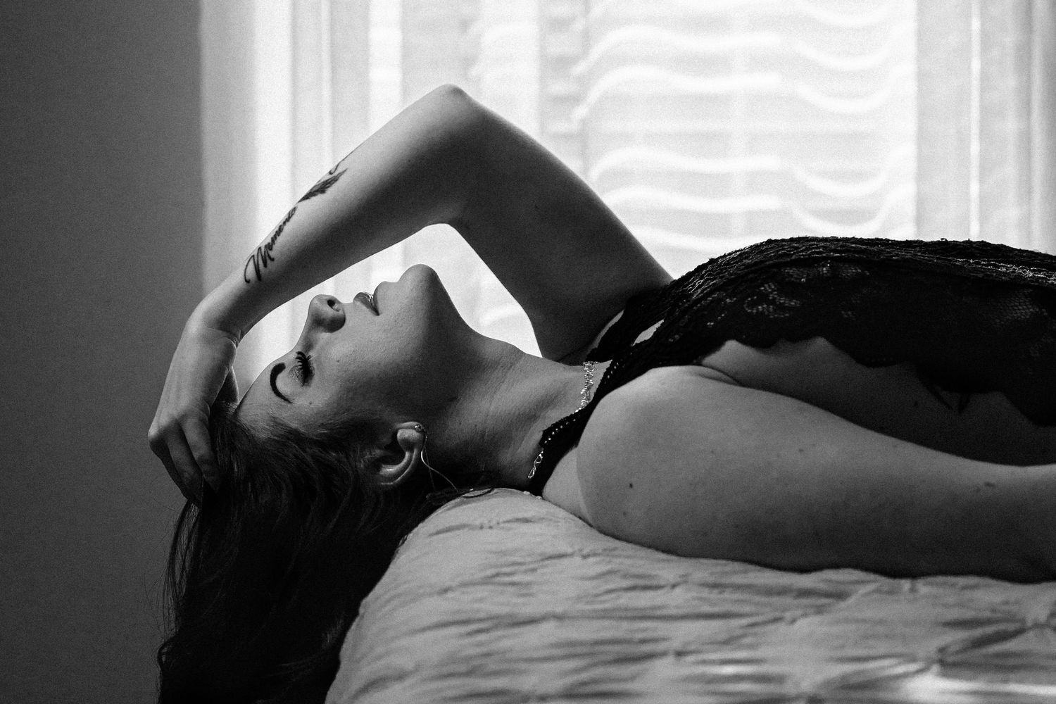 Boudoir portrait of a Knoxville woman laying on a bed taken by dandridge TN boudoir photographer