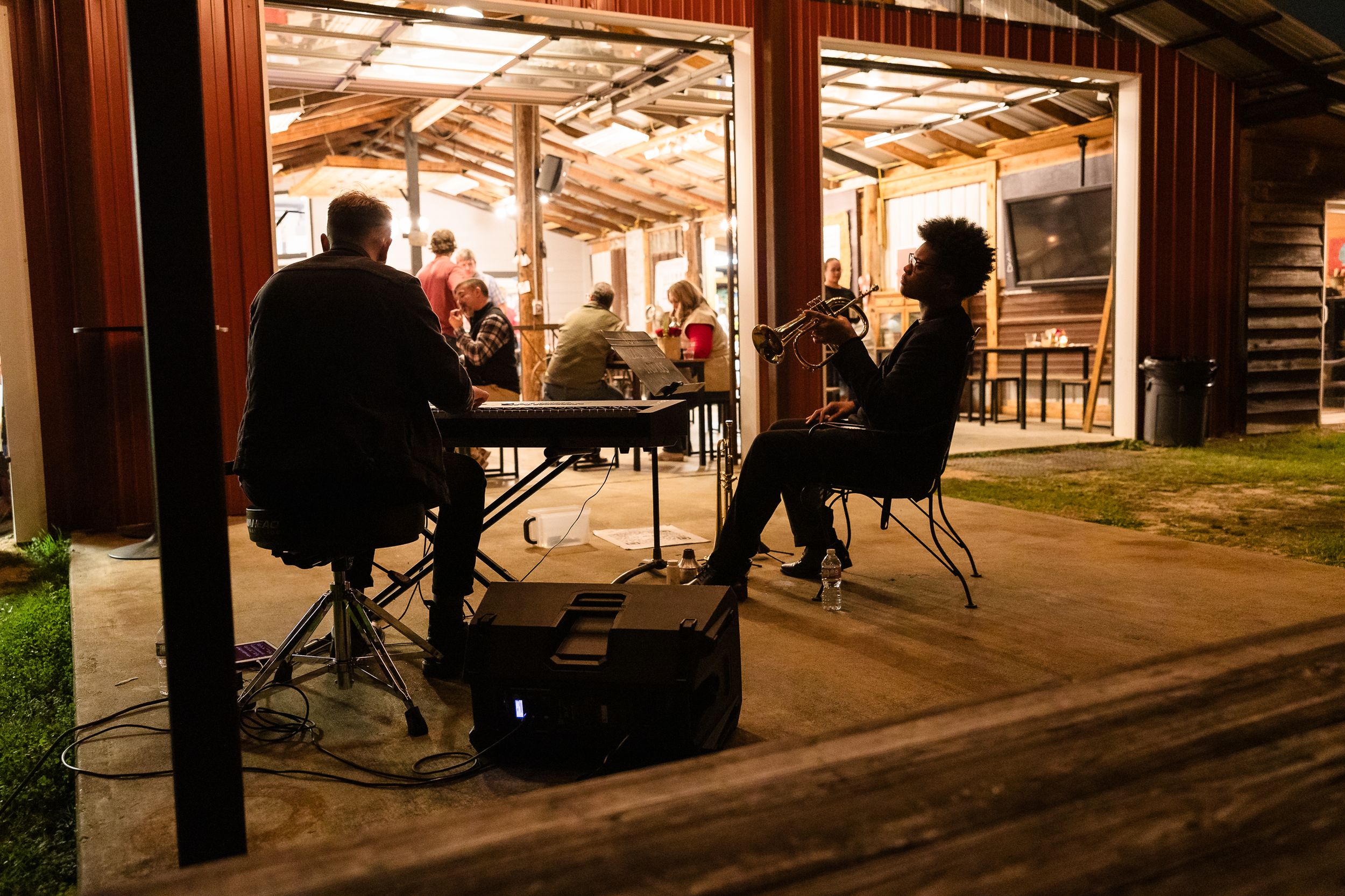 Industrial warehouse space illuminated with warm lighting during evening activities.