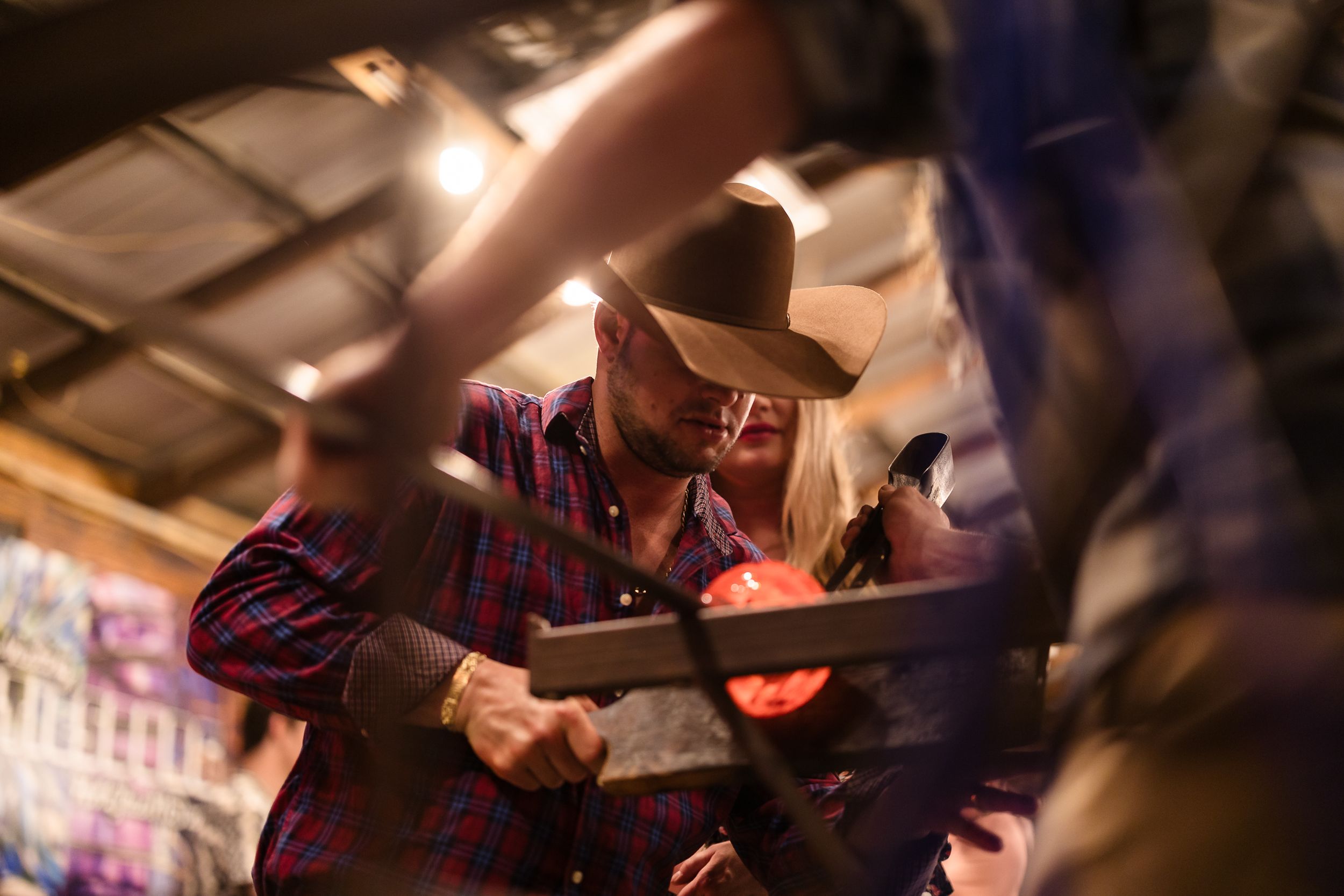 Artists work on creative projects in a warmly lit studio environment.