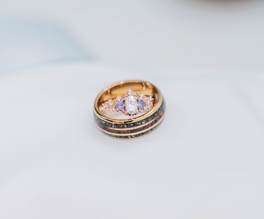 Two wedding rings with intricate details photographed on a light background. The Highgrove Estate, Fuquay-Varina, NC