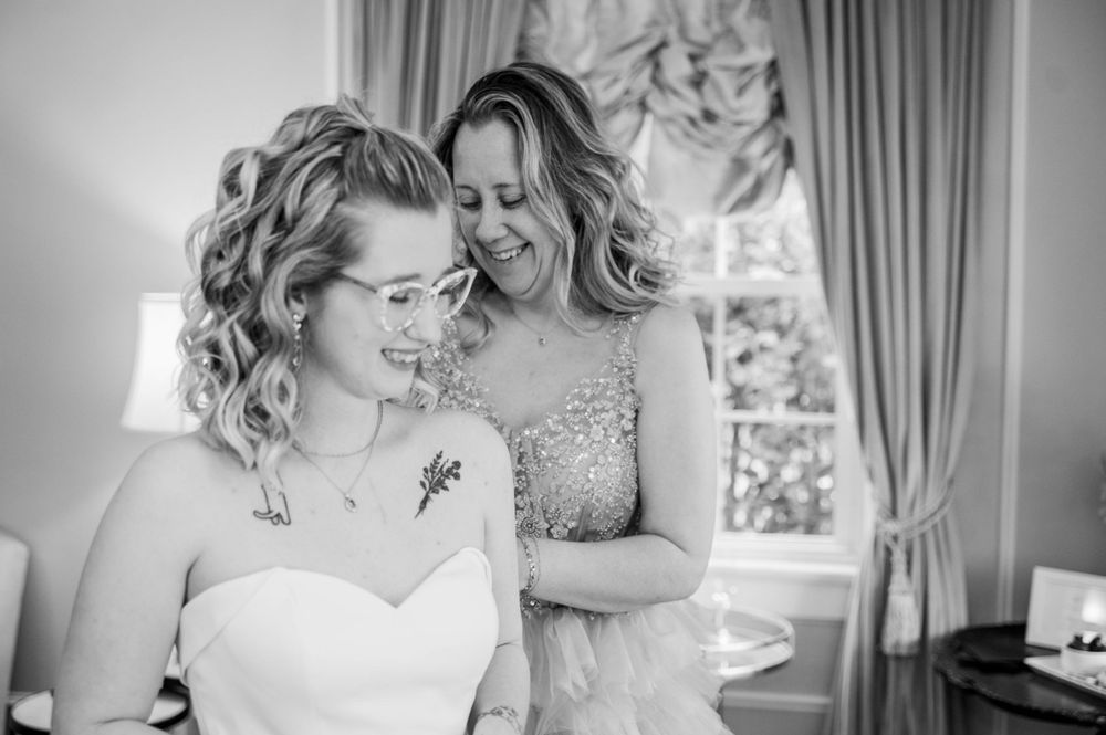 Black and white emotional moment captured during wedding preparation. The Highgrove Estate, Fuquay-Varina, NC