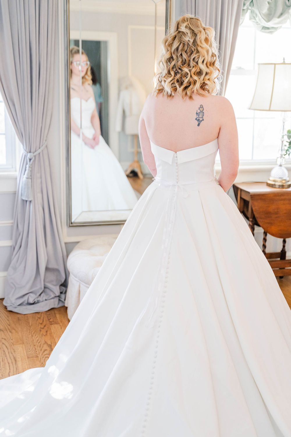 Back view of ballgown wedding dress with tattoo visible through sheer back. The Highgrove Estate, Fuquay-Varina, NC