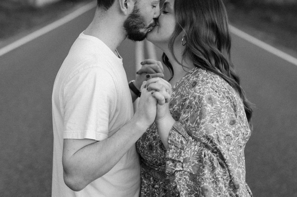 A couple shares a tender moment while dancing on a rural road. Floyd, VA