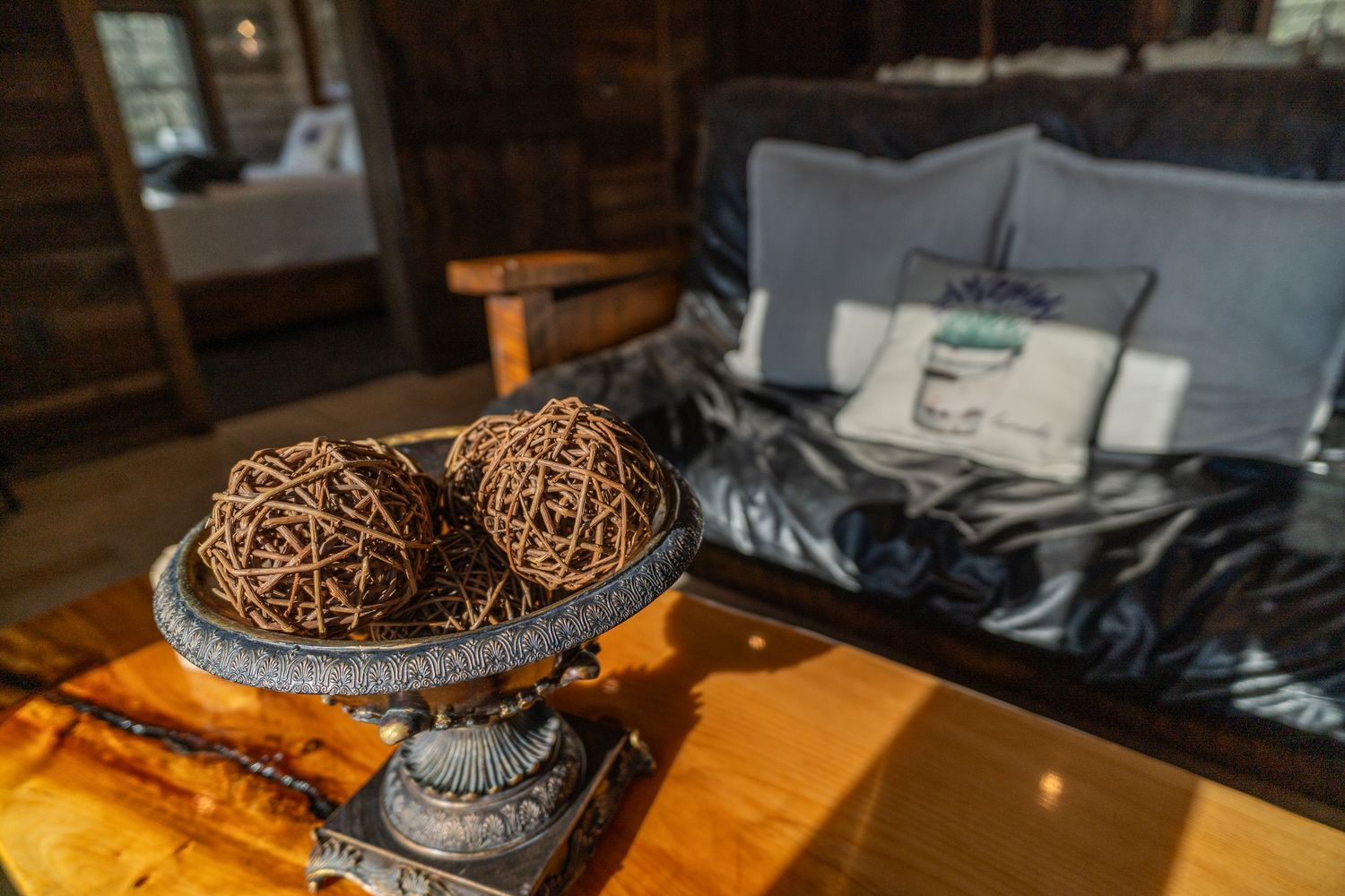 Coffee table centerpiece, set in a cozy wooden house with a couch and pillow featuring lavender design in the background