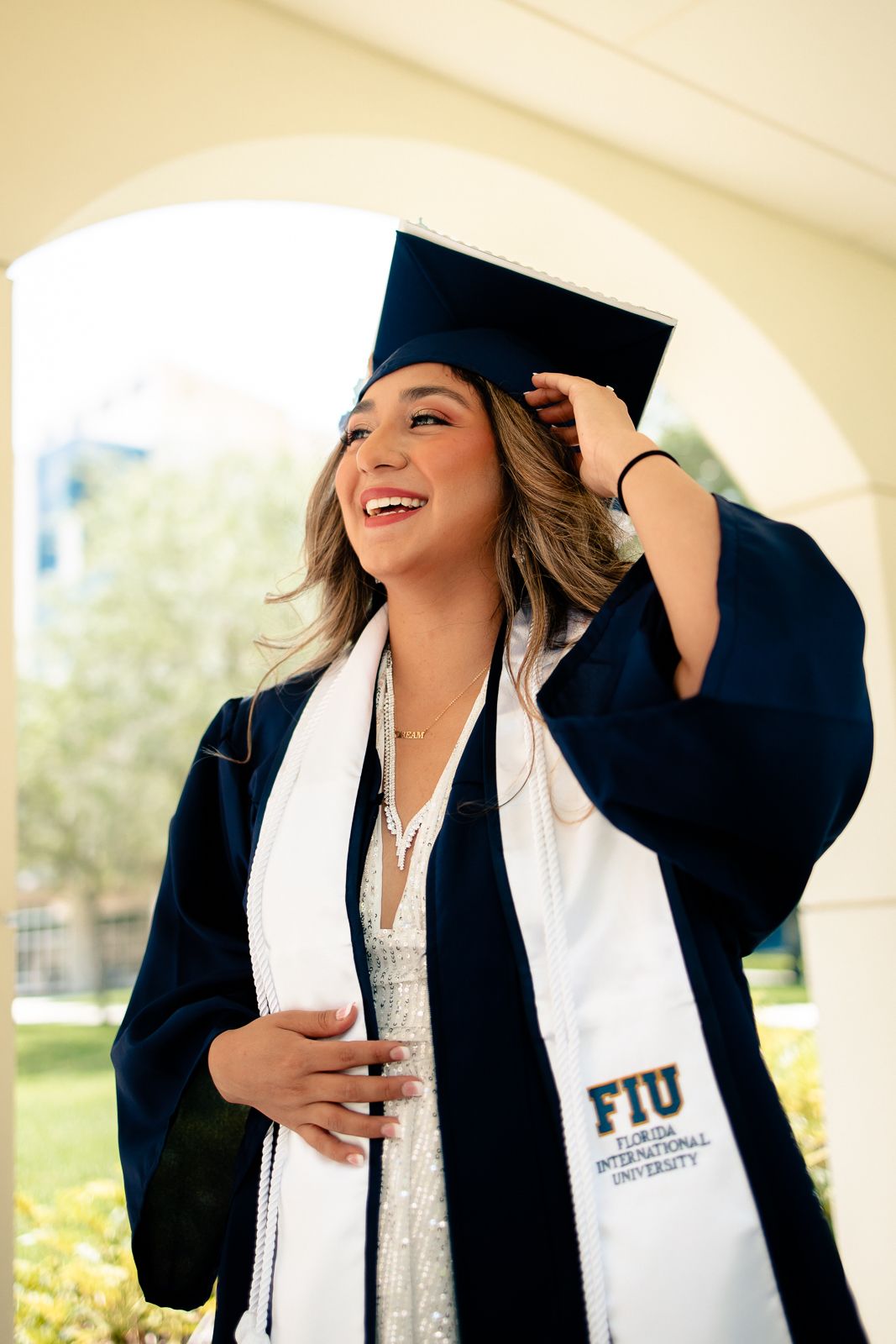 FIU graduation portrait in Miami featuring a student in cap and gown celebrating milestone achievement, South Florida senior and university