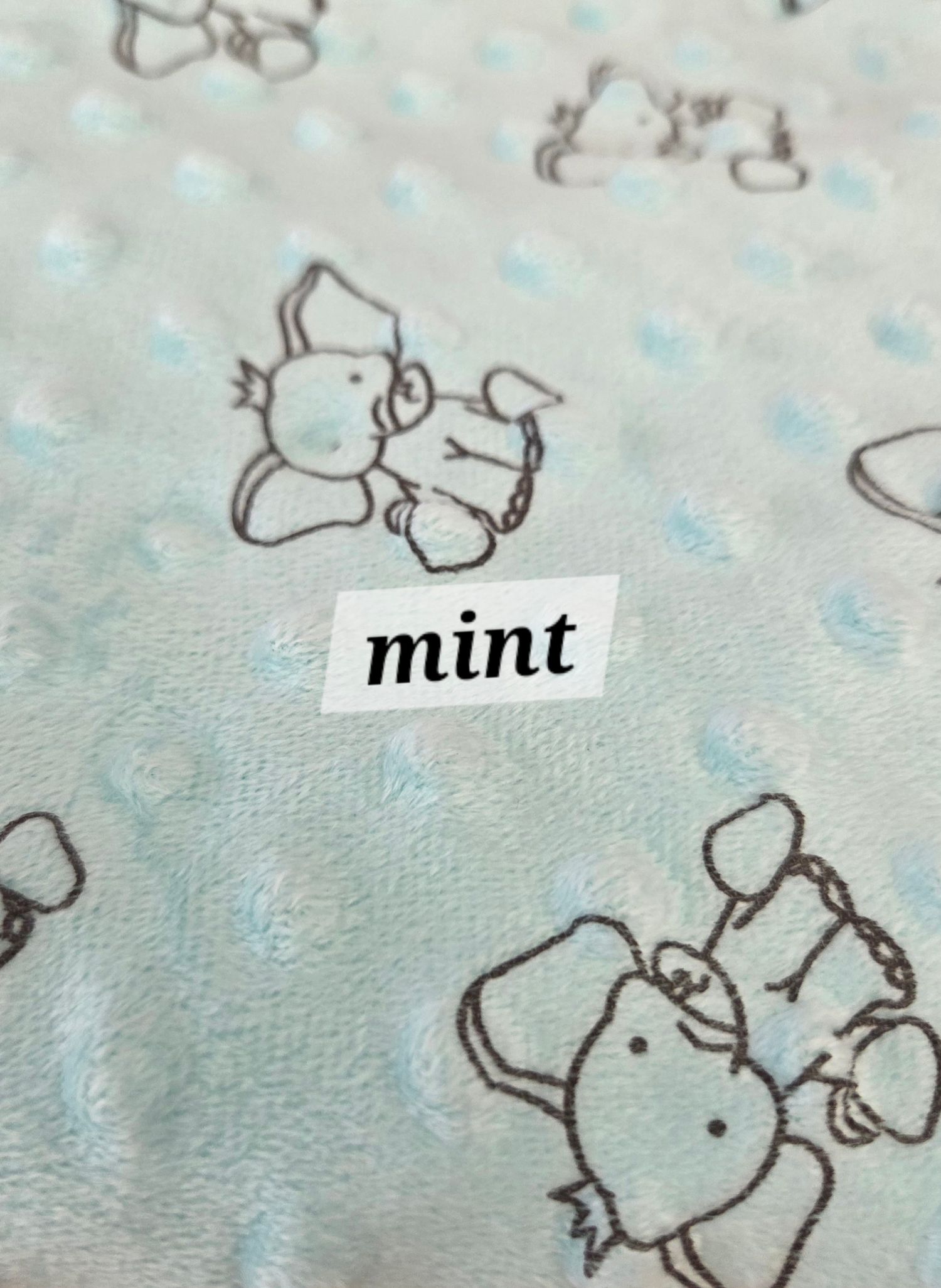 Mint colored minky dot fabric featuring cute elephant print pattern.