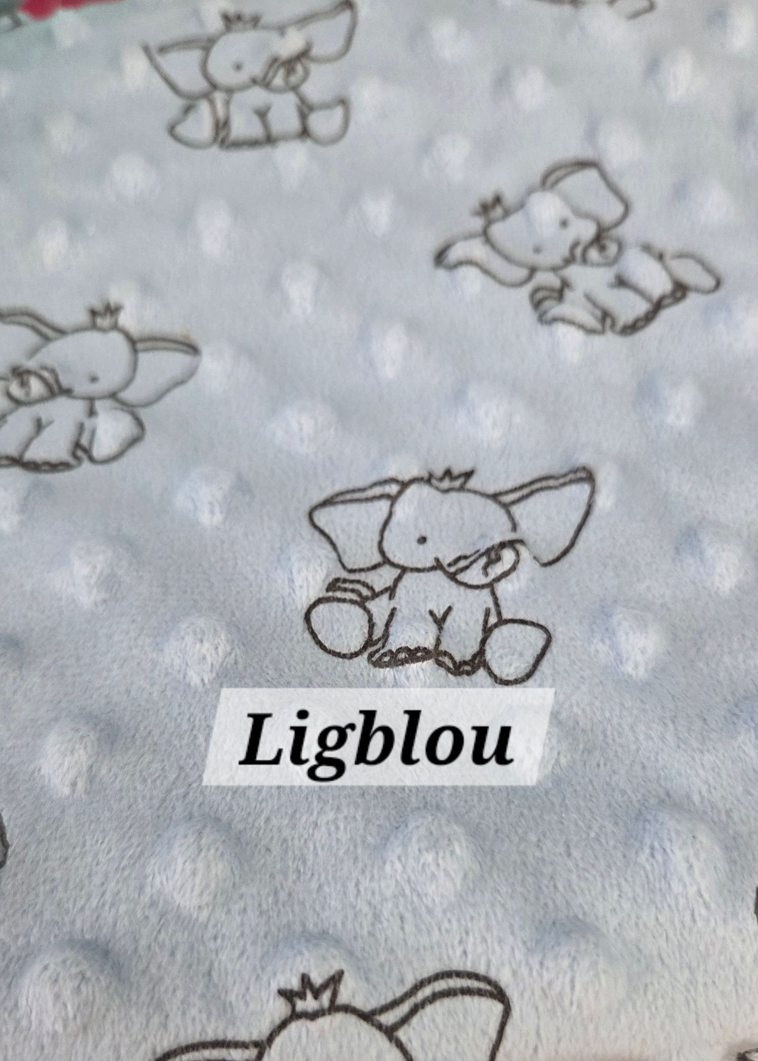 Light blue minky bubble dot fabric featuring cute elephant print pattern, labeled Ligblou, ideal for baby blankets.