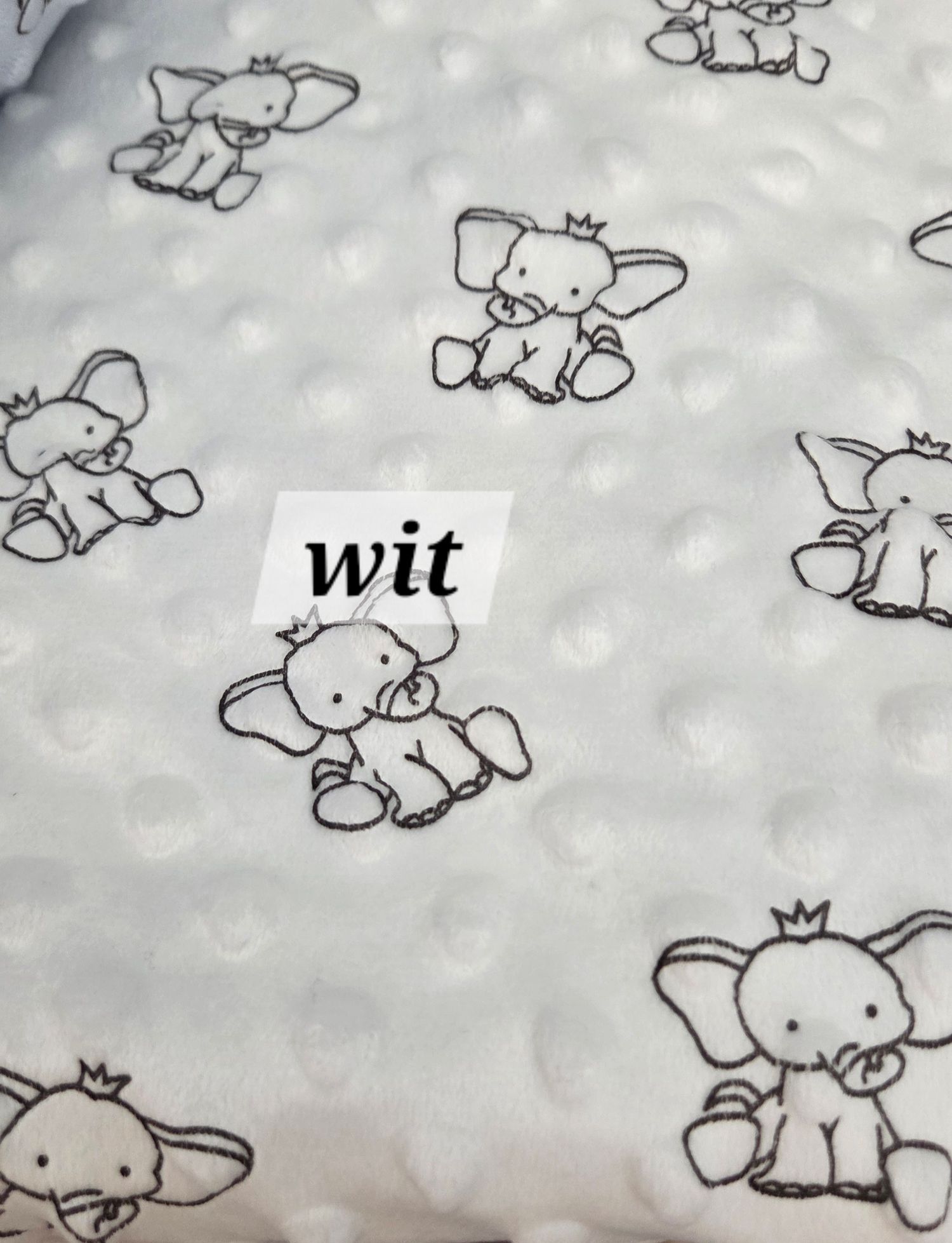 White minky dot fabric with cute elephant print pattern, labeled wit, perfect for baby blankets.