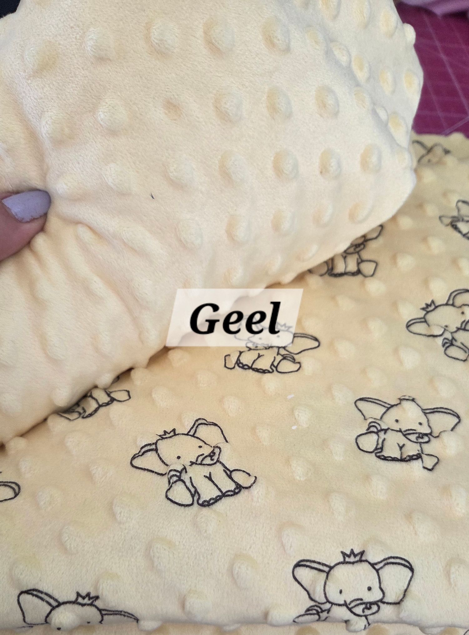 Yellow minky dot fabric and elephant print baby blanket set labeled Geel, soft textured nursery bedding.