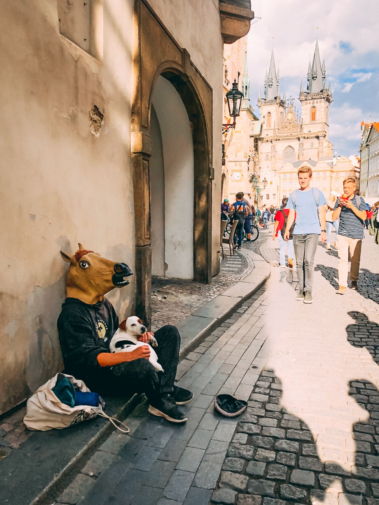 Street musicians performing on cobblestone street with historic architecture in background.