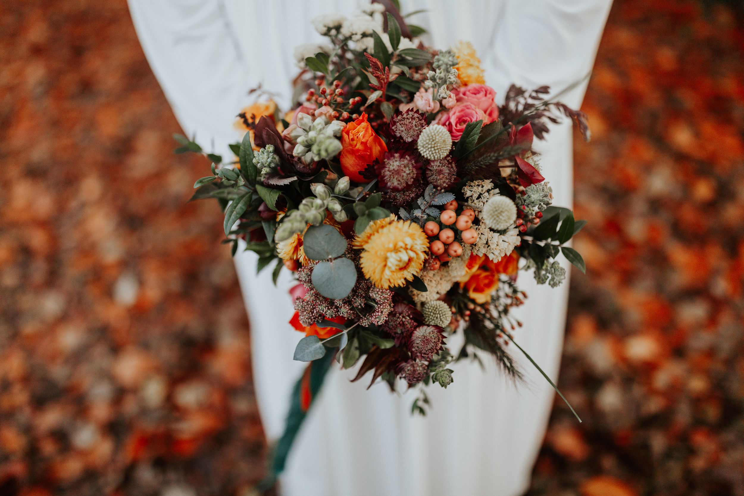 wedding bouquet with seasonal autumn flowers with yellow red green colours