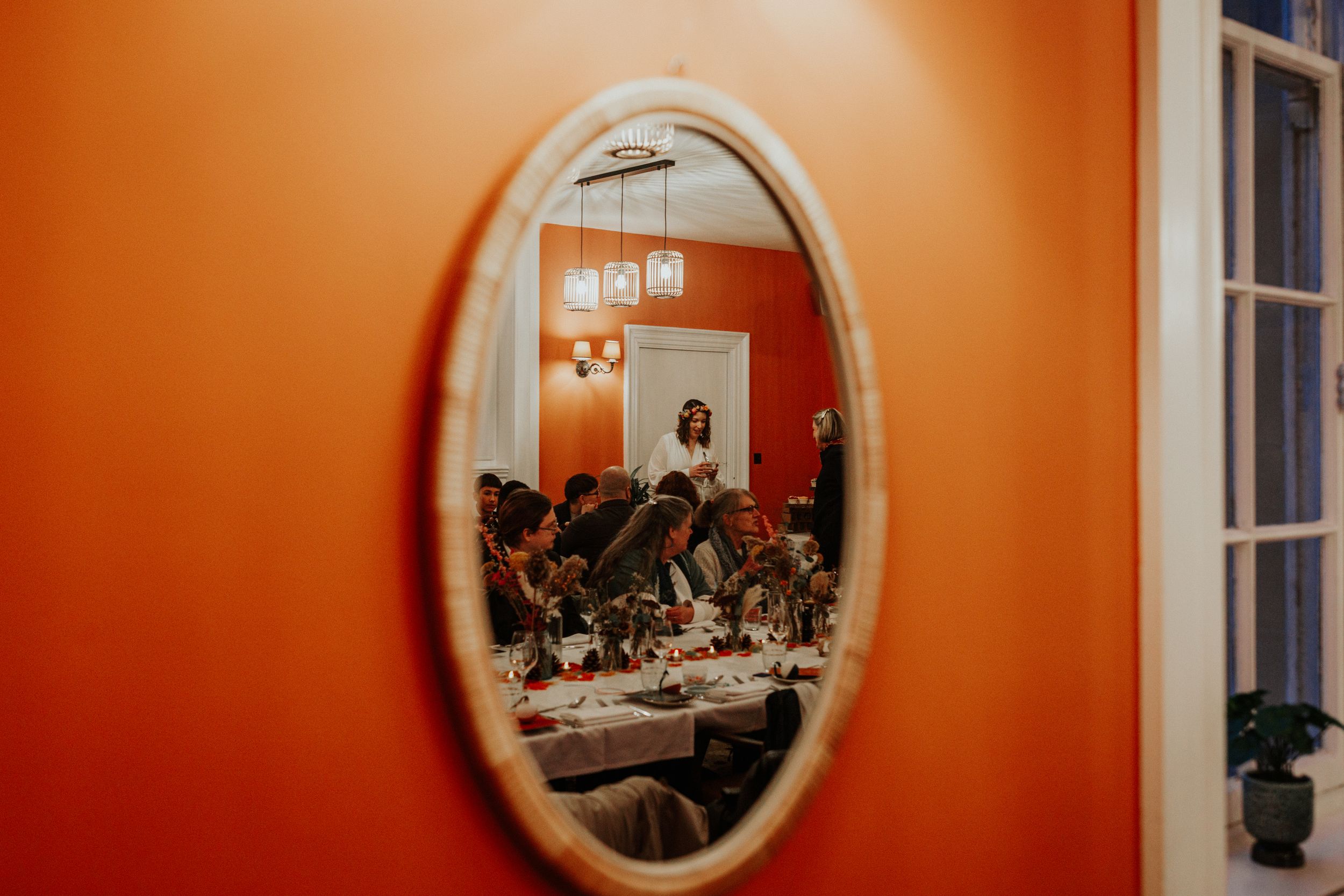 Sanremo Italian restaurant in Bath Wedding reception . Mirror reflect bride with guests chatting