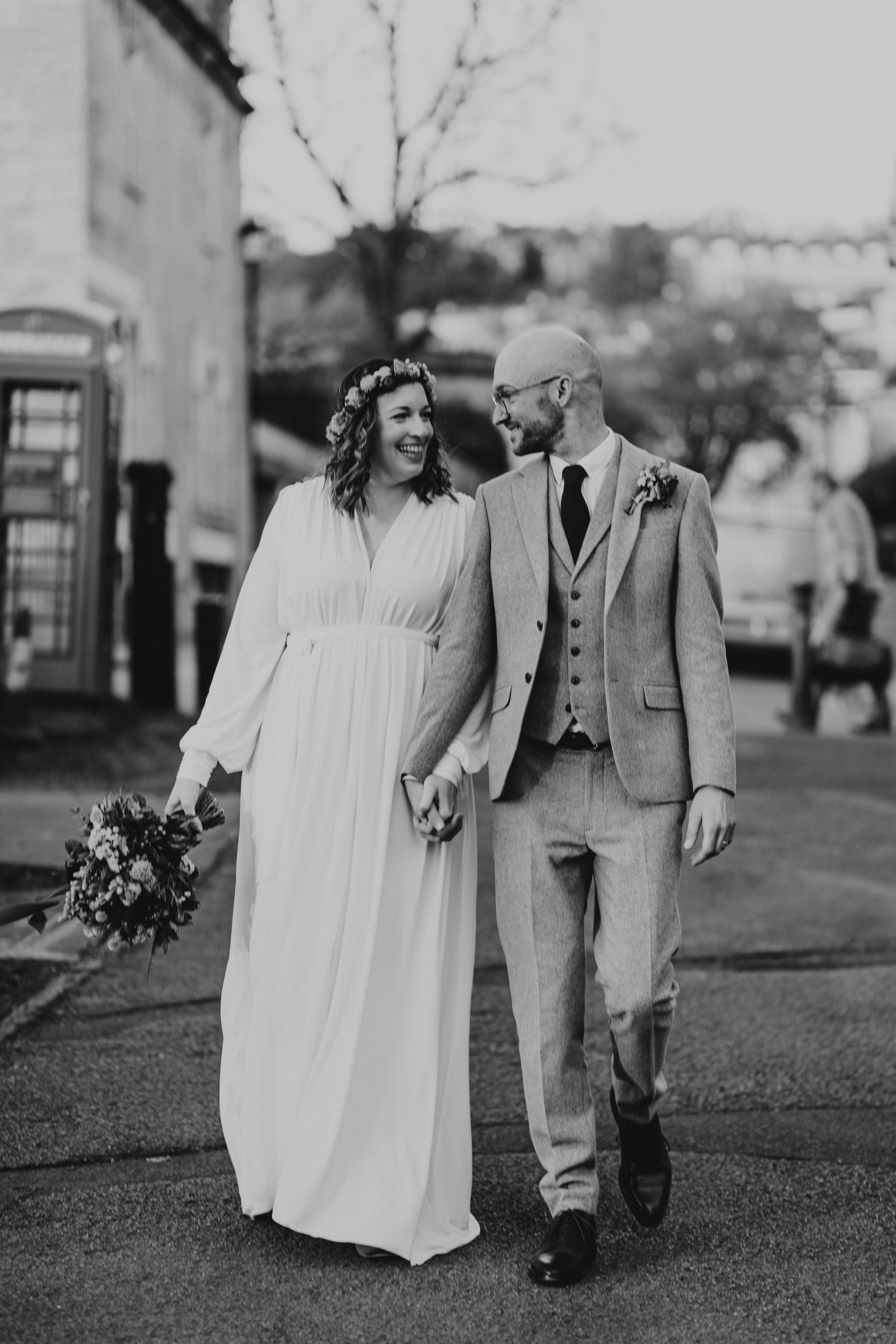 Bride and groom walking portraits  at the Royal Crescent in Bath during golden hour.