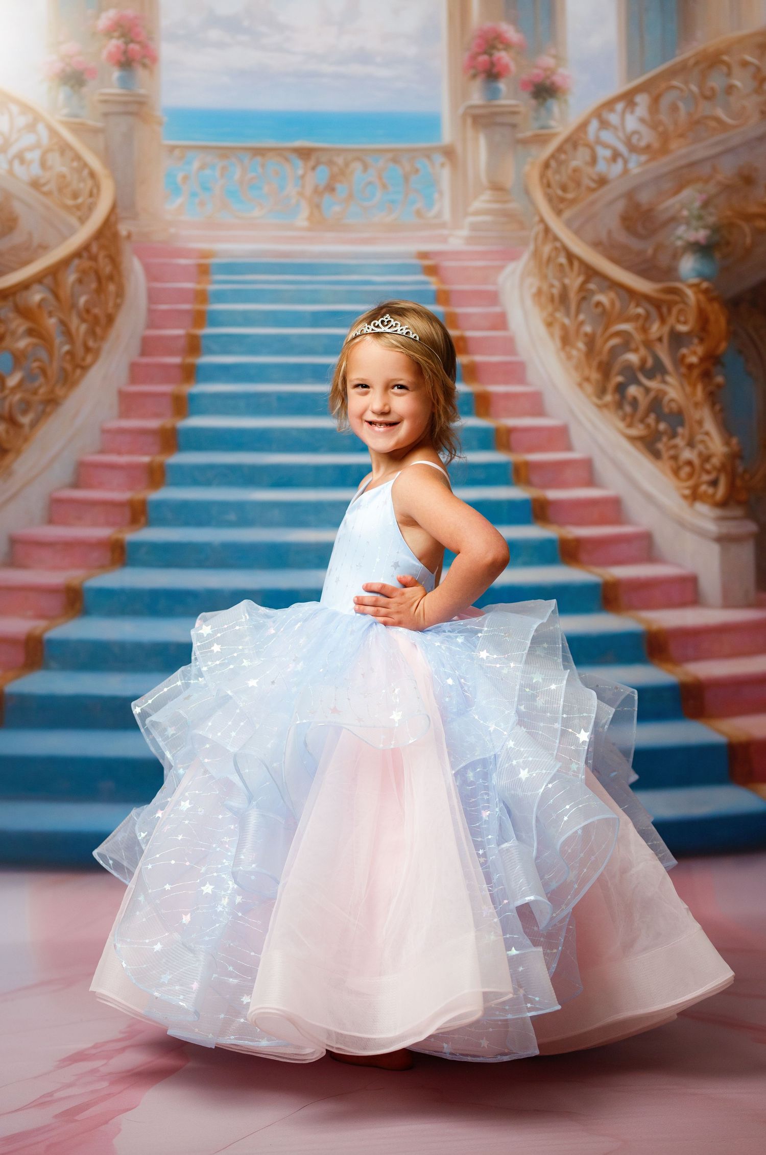 Ethereal portrait in a dreamy blue setting with tulle curtains and a flowing white princess ballgown adorned with blue bows.