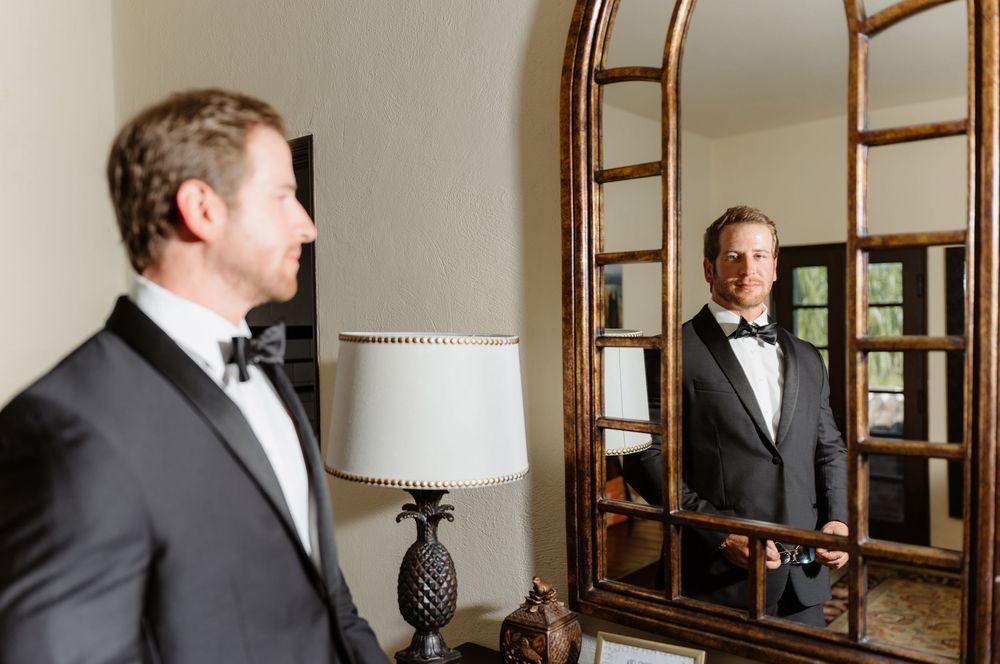 A series of mirror reflections show a person in formal attire adjusting their bow tie in a classic interior space.