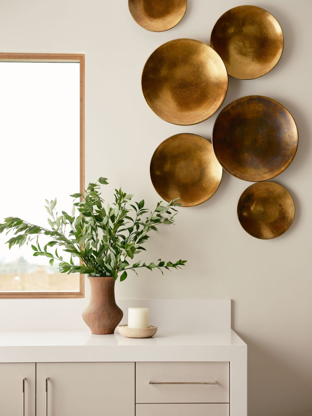 Vanity corner styled with brass wall accents and modern neutral tones — interior detail captured by Khoi Ly in La Jolla.