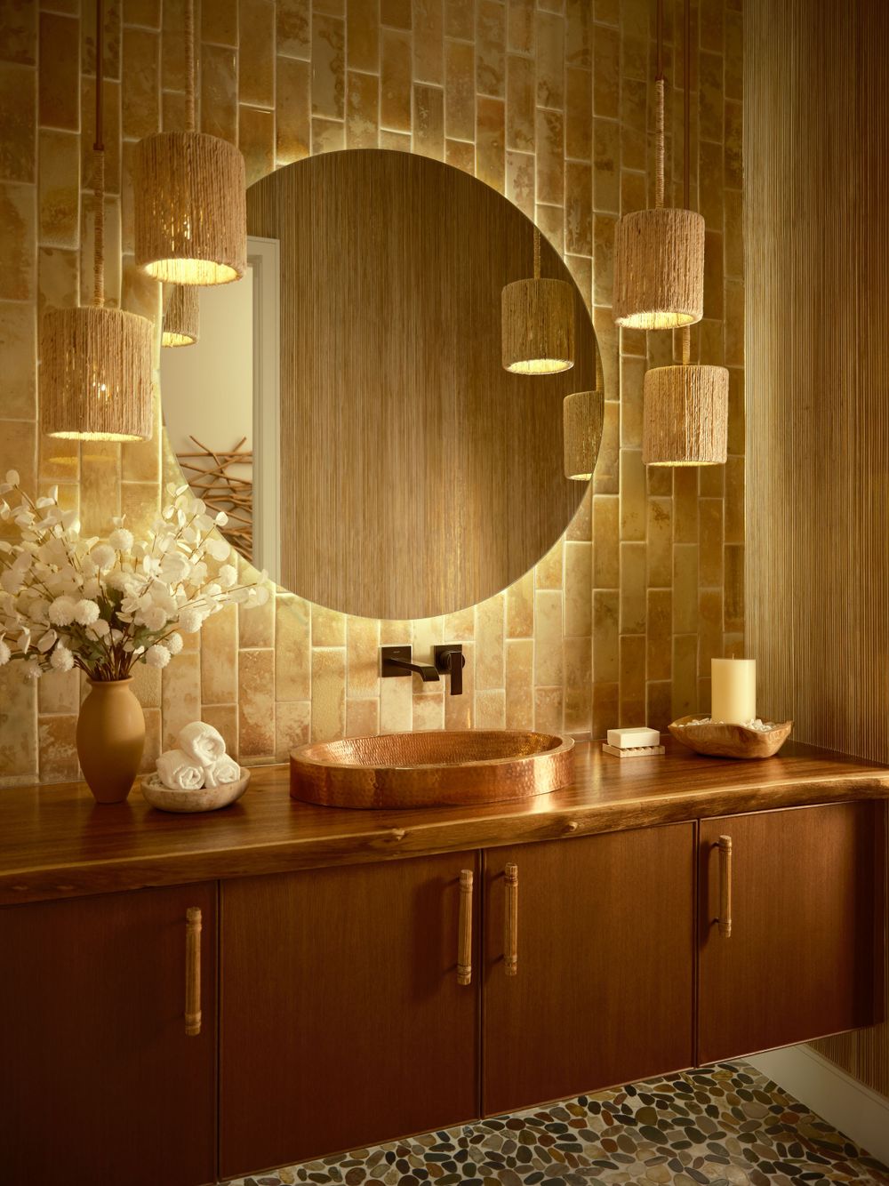 Warm bathroom vignette with circular mirror and gold-tiled backsplash — intimate detail captured by Khoi Ly in La Jolla.