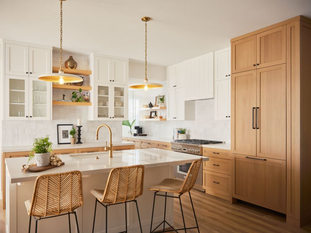 Transitional kitchen with rattan stools, white shaker cabinets, and gold accents — photographed by Khoi Ly for Curry Residence.