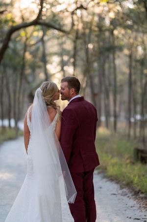 An intimate moment captured on a woodland path during golden hour wedding photography.