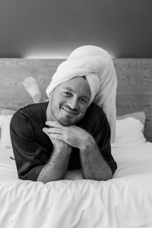 Artistic black and white photography sequence showing someone resting on white bedding.