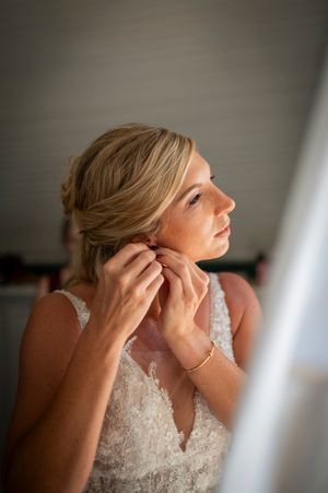 Close-up shots of a bride getting ready putting on earrings in soft natural light.