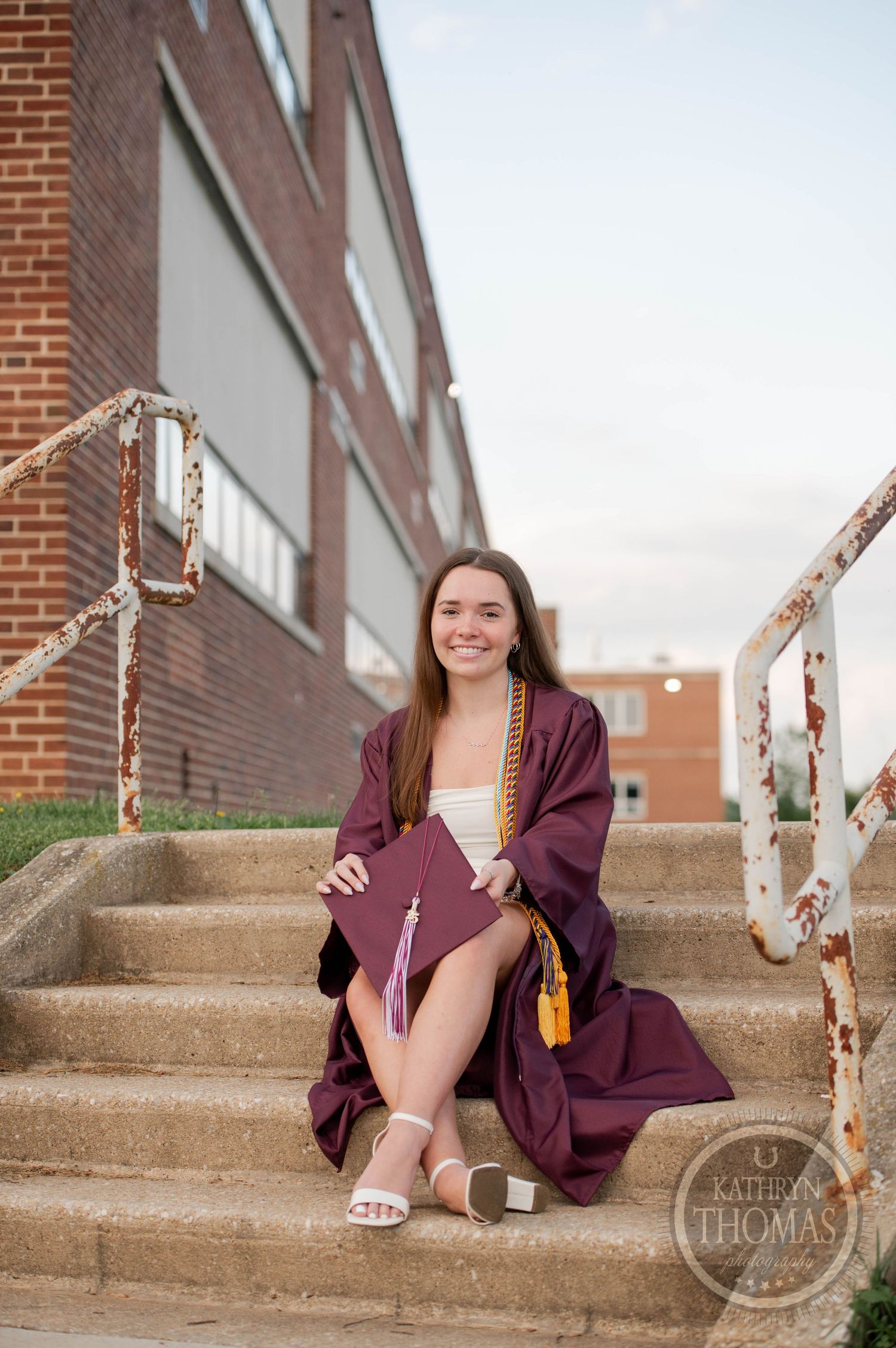 A series of graduation photos on brick steps shows someone in maroon academic regalia posing in various positions.