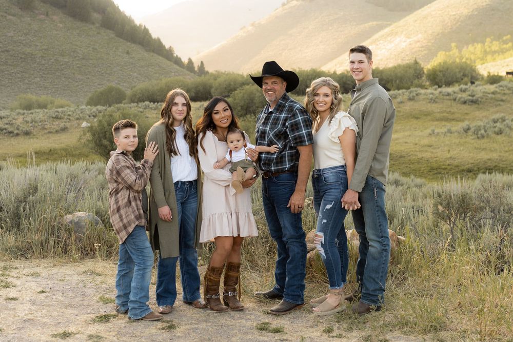 Large family group photo session on beautiful mountain landscape with natural vegetation.