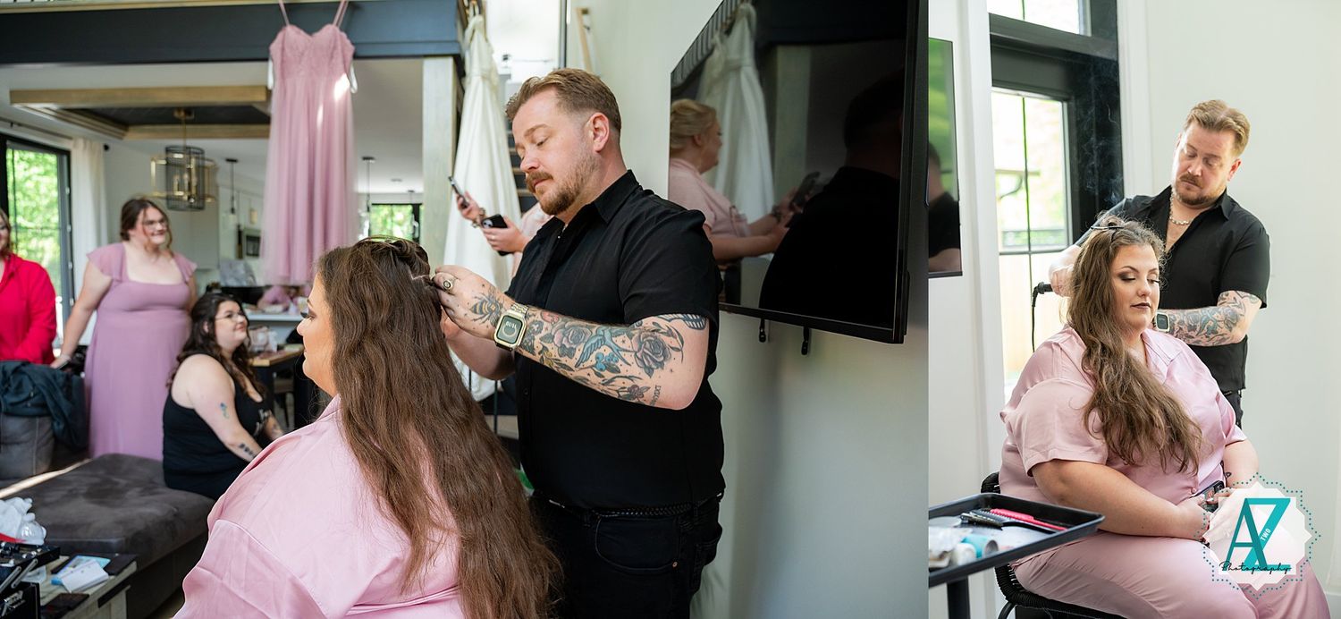 Stylist working in a salon with pink decor and dress form displays in the background.