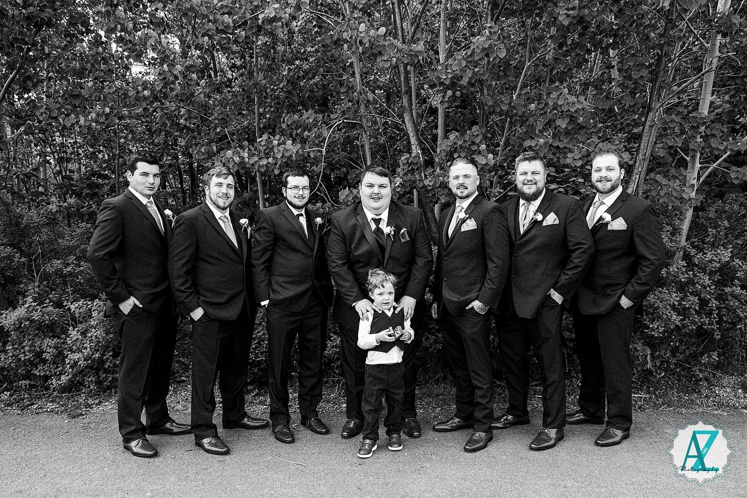 Creative wedding party photo showcasing everyones shoes aligned in black and white.