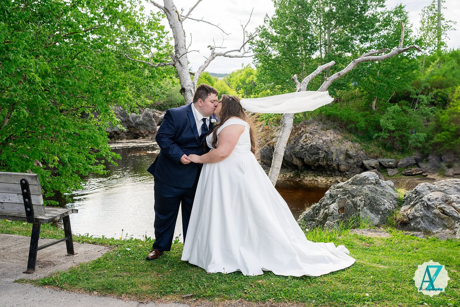 A romantic outdoor wedding shoot in a lush green garden setting with flowing white dress and elegant poses.