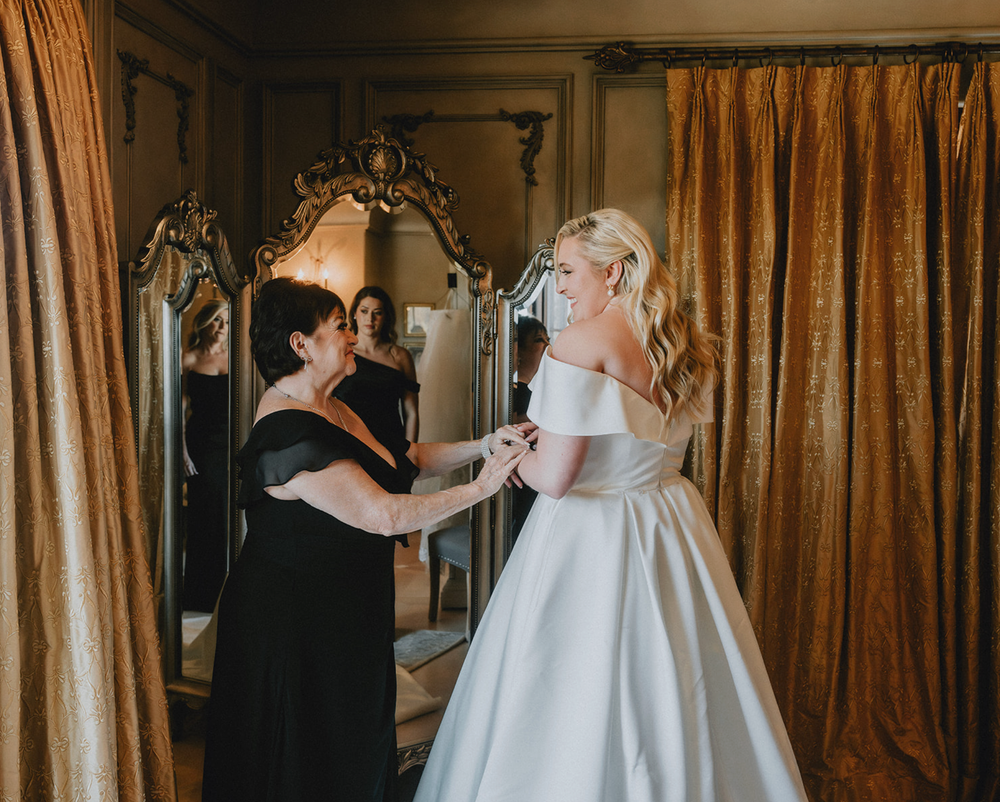 Emotional wedding portrait of bride and mother sharing a moment at Chase House in Baltimore City.