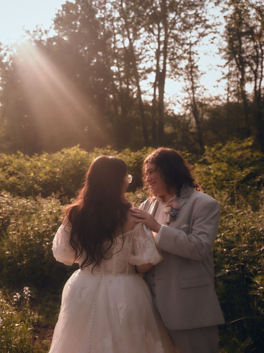 Romantic wedding portraits of husband and wife standing in front of wildflowers in Western Maryland Appalachia.