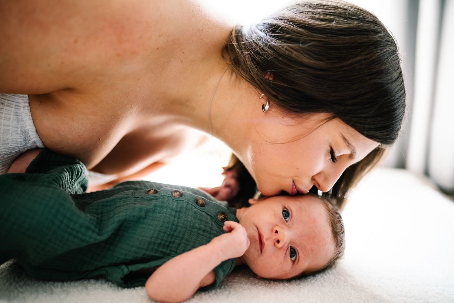 A tender parenting moment captured in soft light taken by Melbourne newborn photographer.