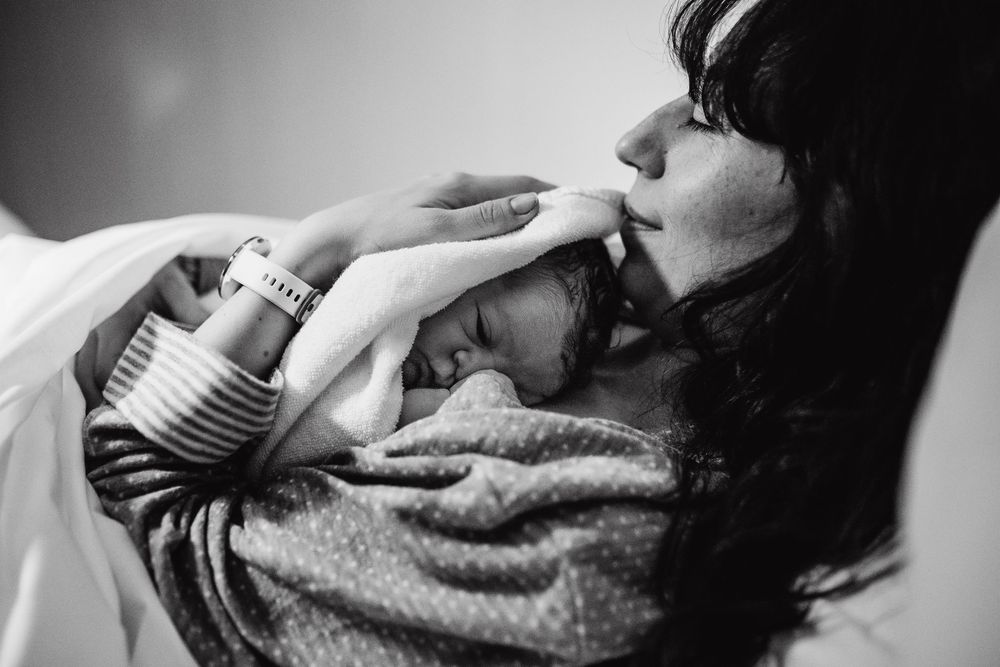 Dramatic black and white composition of medical care moment.