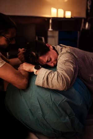 Warm-toned photographs documenting a birth experience in a medical setting.