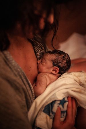 Close-up shots of a newborn immediately after birth.
