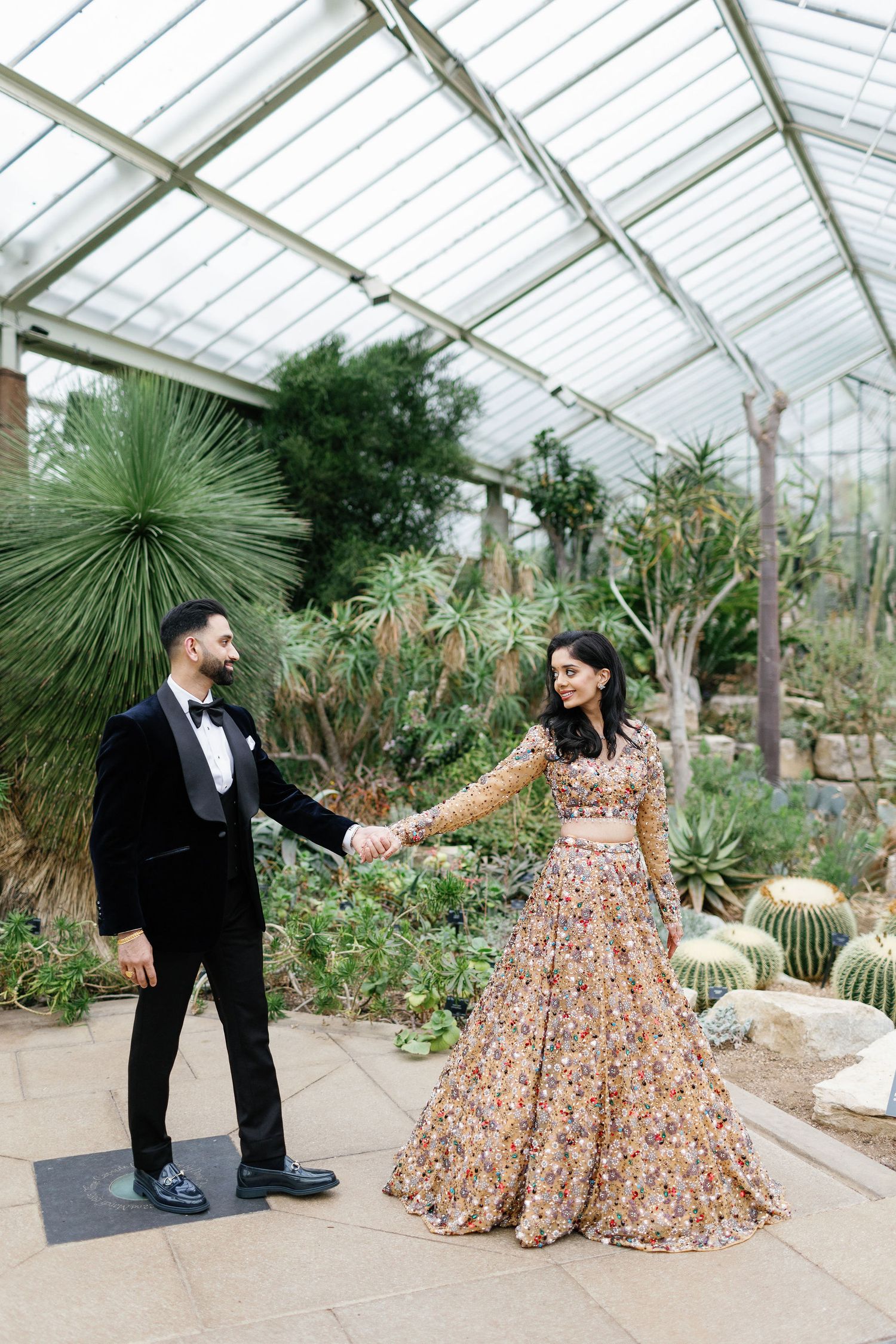 Fashionable Joyful Indian bride and groom at Princess of Wakes Conservatory at Kew Gardens