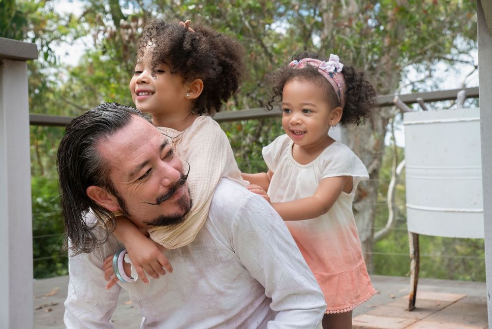 Family photoshoot, playful daughters with their father.  capturing the fun.