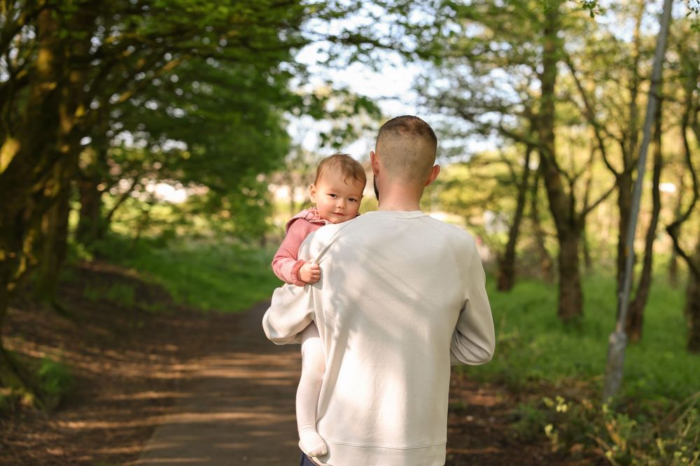 Father and daughter during an outdoor session. golden hour highlighting the bond between Daddy and daughter.