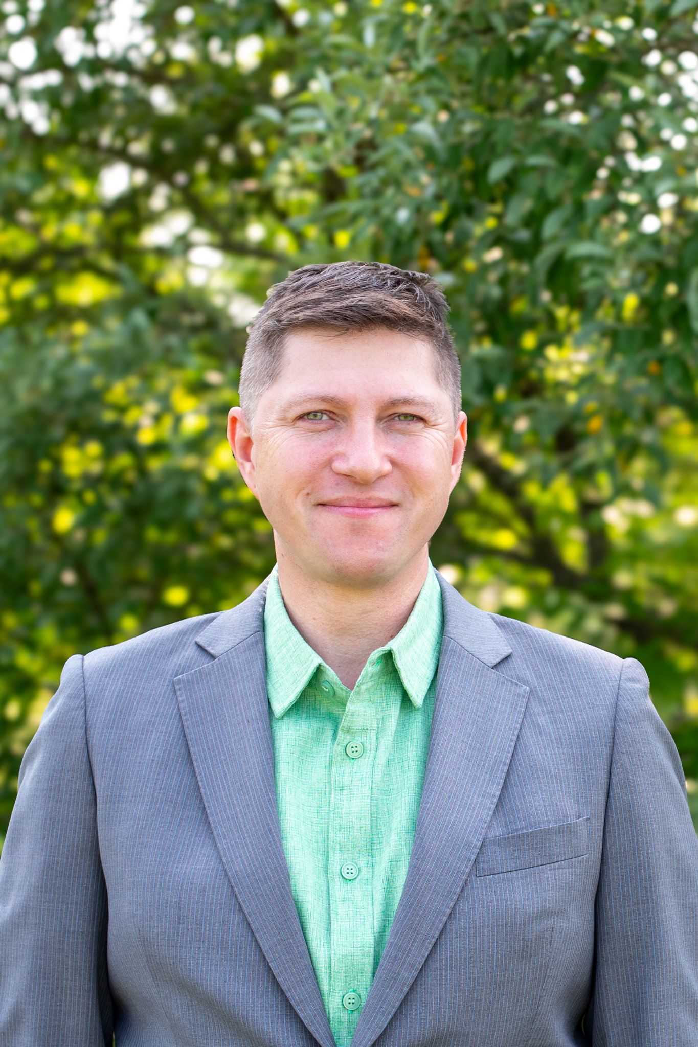 Outdoor headshot of man in Cincinnati with professional lighting and polished styling for high-end business and personal branding clients